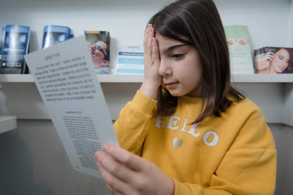 A female kid reading myopia control test