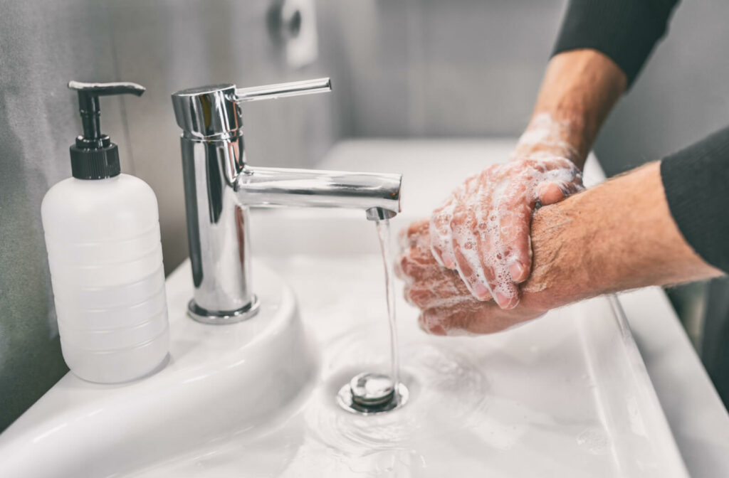 Washing hands and rubbing with soap man for hygiene, before touching contact lenses