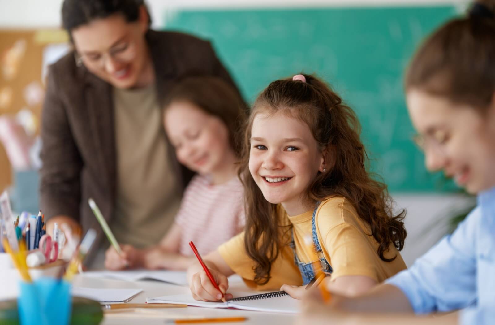 A child doing schoolwork at their desk at school.