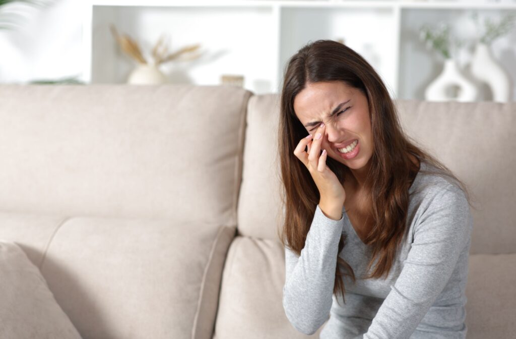 A person rubbing their dry eyes